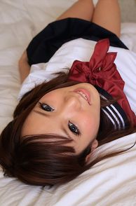 Pretty Eyes Asian In Uniform Laying On The Bed